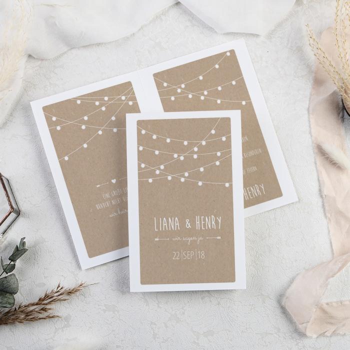 Hochzeitseinladung mit weißen Lampions im Packpapierdesign