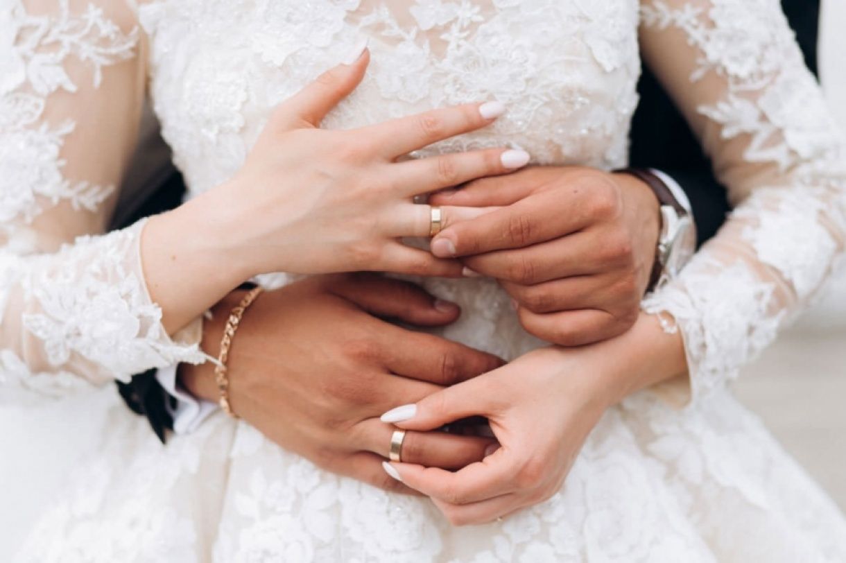 groom-and-bride-are-putting-on-wedding-rings-front-view-of-hands-freepik
