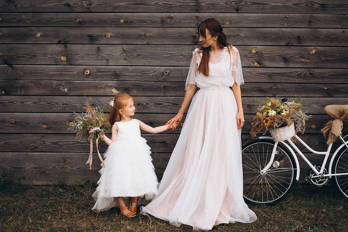 mother-with-daughter-in-beautiful-dresses-by-the-bicycle